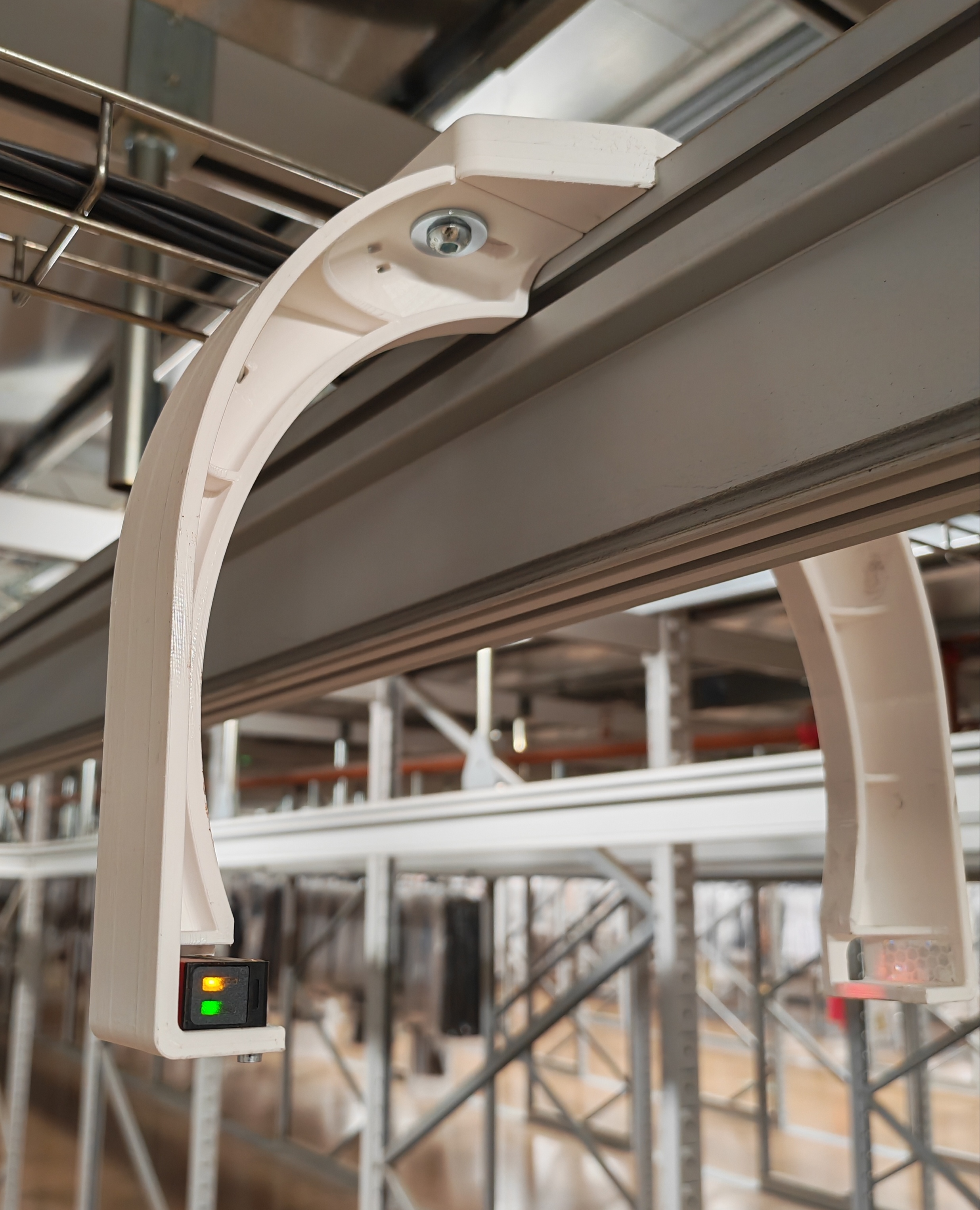 3D printed sensor bracket installed on conveyor system