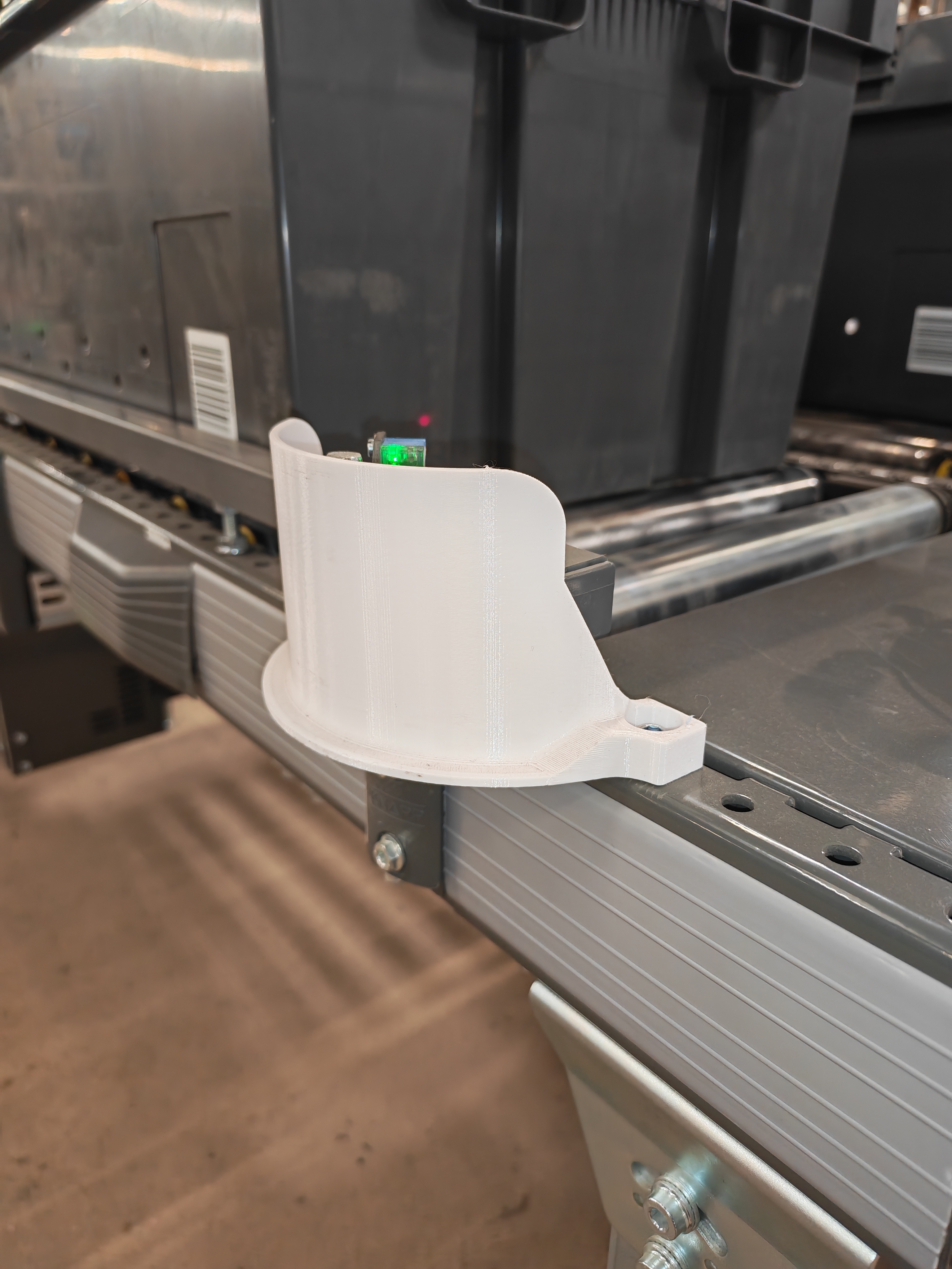 3D printed sensor guard installed on roller conveyor
